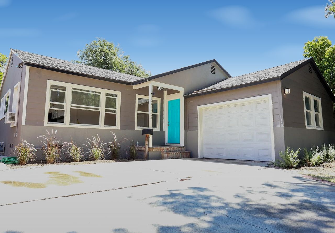 Gray house with a turquoise front door at 19422 Archwood St, Reseda