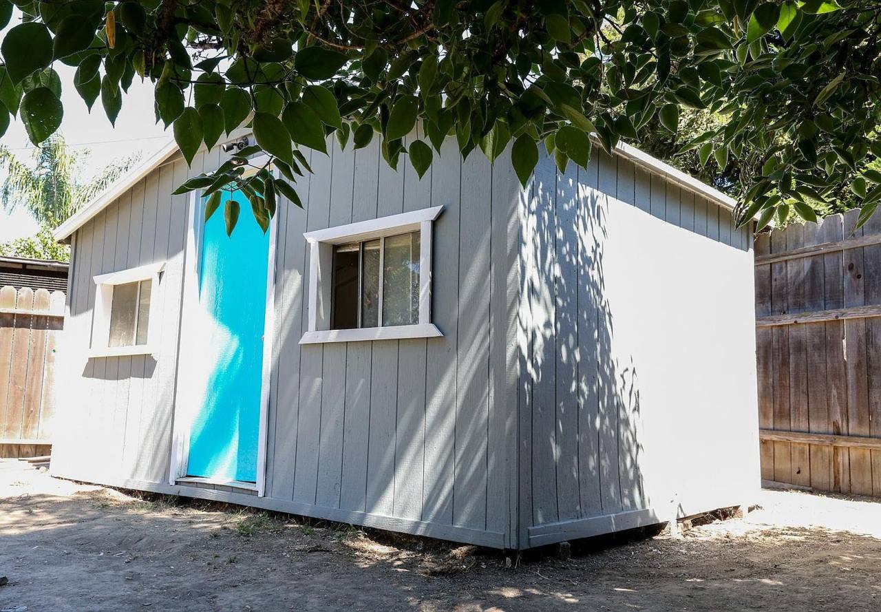 Backyard work shed with a turquoise door at 19422 Archwood St, Reseda